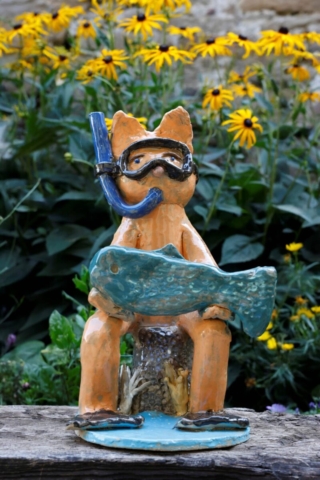 Theov potápač v kvetinovom záhone